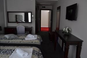 Postel nebo postele na pokoji v ubytování Hotel Emi