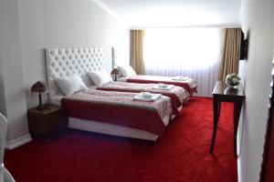 Postel nebo postele na pokoji v ubytování Hotel Emi