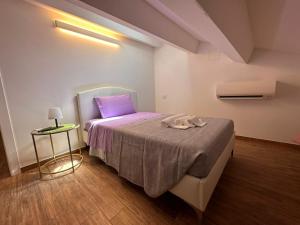 a bedroom with a bed with a purple pillow at B&B La Fortezza in Comacchio