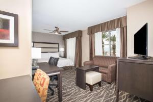 a hotel room with a bedroom with a bed and a television at Homewood Suites by Hilton South Las Vegas in Las Vegas