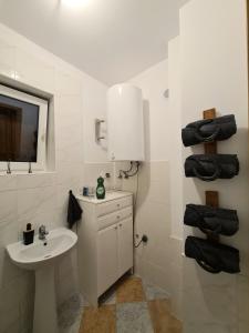 a white bathroom with a sink and a mirror at Agroturystyka Galant in Połęczyno