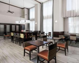 a dining room with tables and chairs and windows at Hampton Inn & Suites Lubbock in Lubbock