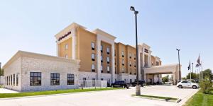 a building with a car parked in front of it at Hampton Inn & Suites Liberal in Liberal