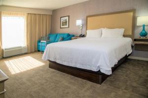 a hotel room with a large bed and a chair at Hampton Inn Lewisburg in Lewisburg +29 photos