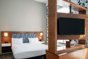 a hotel room with a bed and a flat screen tv at Hampton Inn & Suites Sherman Oaks in Sherman Oaks