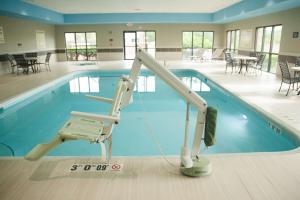 a swimming pool with a ladder in front of it at Hampton Inn - North Platte in North Platte