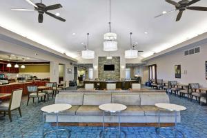 a lobby with tables and chairs and a couch at Homewood Suites by Hilton Lexington Fayette Mall in Lexington