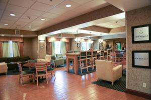 a lobby with tables and chairs and a bar at Hampton Inn Morehead in Morehead