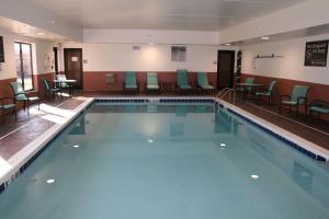 a large swimming pool with chairs and tables at Hampton Inn Morehead in Morehead