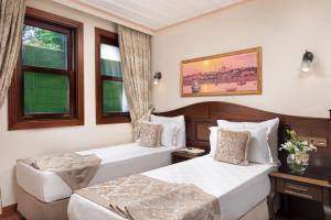 Postel nebo postele na pokoji v ubytování Bender Hotel