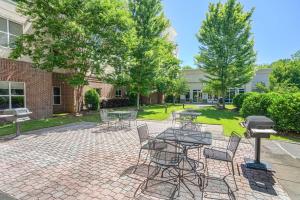 a patio with a table and chairs and a grill at Hampton Inn & Suites West Little Rock in Little Rock