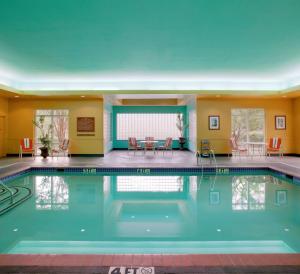 a large swimming pool in a hotel room with a pool at Hampton Inn & Suites West Little Rock in Little Rock