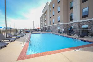 a large swimming pool in front of a building at Hampton Inn & Suites Bay City in Bay City