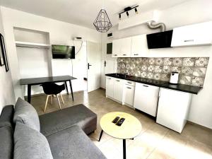 a living room with a couch and a table at Familly Apartament 6 in Międzyzdroje