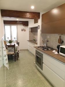 a kitchen with a sink and a stove top oven at RistoriApartment in Florence
