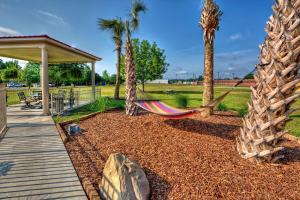 a hammock in a garden with palm trees at Hampton Inn Laurinburg in Laurinburg