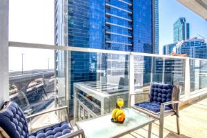 a balcony with two chairs and a table on a building at Exquisite 1 BDR apt in the heart of Dubai Marina- Studio One Tower in Dubai