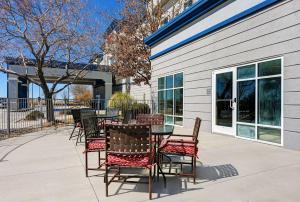 a patio with a table and chairs next to a building at Hampton Inn Deming in Deming