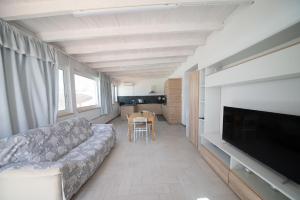 a living room with a couch and a table at 10 e Lode in Mazara del Vallo