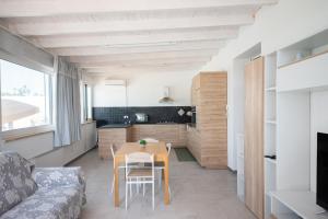 a kitchen and living room with a table and chairs at 10 e Lode in Mazara del Vallo