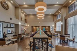 a lobby of a restaurant with tables and chairs at Hampton Inn & Suites Las Cruces I-25 in Las Cruces