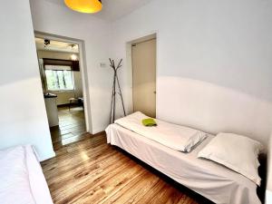 a bedroom with two beds and a mirror at Familly Apartament 6 in Międzyzdroje