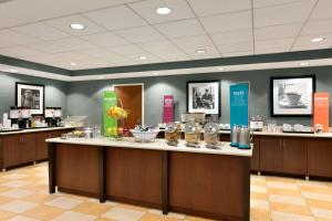 a large lobby with a counter with glasses on it at Hampton Inn & Suites Mahwah in Mahwah