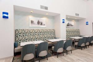 a dining room with tables and chairs at Hampton Inn & Suites McComb in McComb