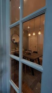 a view of a dining room through a window at Stylish home close to Arena in Wincobank