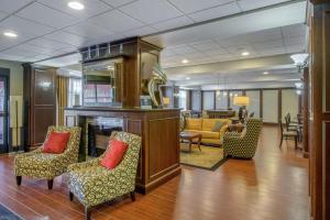 a lobby with chairs and a fireplace in a building at Hampton Inn Meadville in Meadville