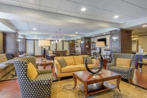a living room with couches and chairs and a table at Hampton Inn Meadville in Meadville