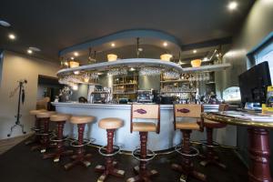 a bar with stools in front of a counter at L'HÔTEL de CHARTRES in Chartres