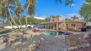 a house with a swimming pool in front of a house at Decked Out on Marbury in Longboat Key