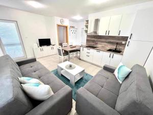 a living room with a couch and a table at Apartments Possedaria in Posedarje