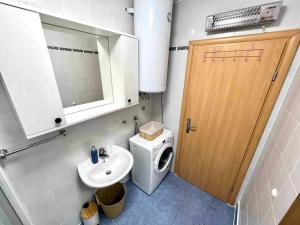 a bathroom with a sink and a toilet and a door at Apartments Possedaria in Posedarje +12 photos