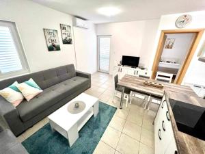 a living room with a couch and a table at Apartments Possedaria in Posedarje