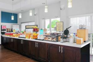 a cafeteria with a counter with boxes of food at Hampton Inn Lake Buena Vista / Orlando in Orlando