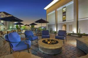a patio with chairs and a fire pit in front of a building at Hampton Inn Marietta in Marietta