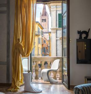 a room with a view of a city through a window at Billie's Flat RED - art & design apt in Verona historic centre in Verona