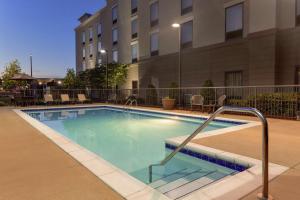 a swimming pool in front of a building at Hampton Inn & Suites Prattville in Prattville