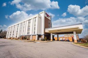 a large white hotel building with a parking lot at Hampton Inn Morgantown in Morgantown