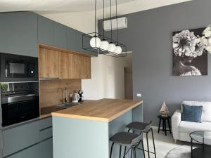 a kitchen with blue cabinets and a table and chairs at Vitas Apartments in Zaton