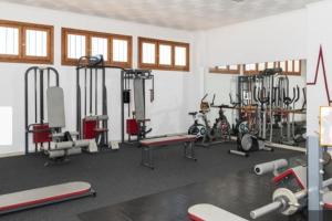 a gym with bikes and machines in a room at Apartamentos Bon Amb in Faro de Cullera