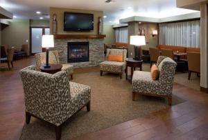 a waiting room with chairs and a fireplace at Hampton Inn Mitchell in Mitchell