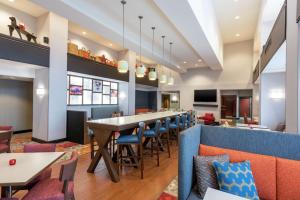 a dining room with a long table and chairs at Hampton Inn & Suites Marshalltown in Marshalltown