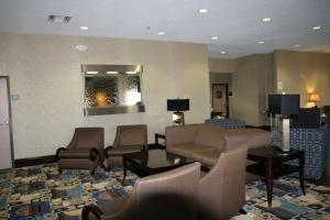 a waiting room with chairs and a couch and a table at Hampton Inn Olathe in Olathe