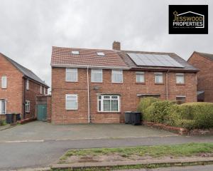 a brick house with solar panels on the roof at 6 Bedroom Contractor House at Jesswood Properties Short Lets With Parking,Wifi & Pool Table in Luton