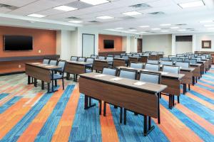 a classroom with tables and chairs and a tv at Hampton Inn & Suites Marshalltown in Marshalltown