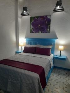 Postel nebo postele na pokoji v ubytování Hotel Concepción Antioquia
