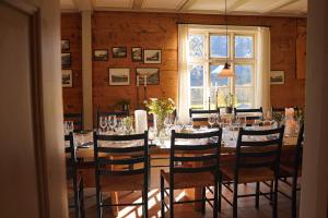 a dining room with a long table with wine glasses at Hotel Aak in Åndalsnes